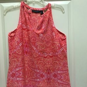 Woman’s sleeveless, cut in shoulder top.